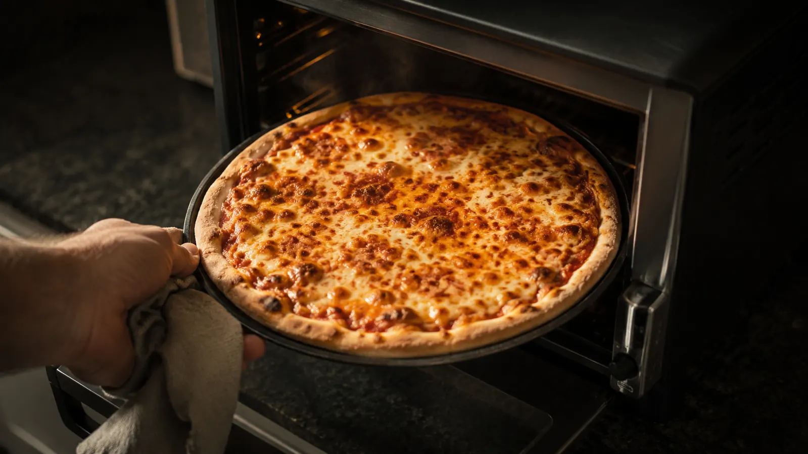 Freshly baked pizza with bubbling cheese on a pizza pan inside the Breville oven