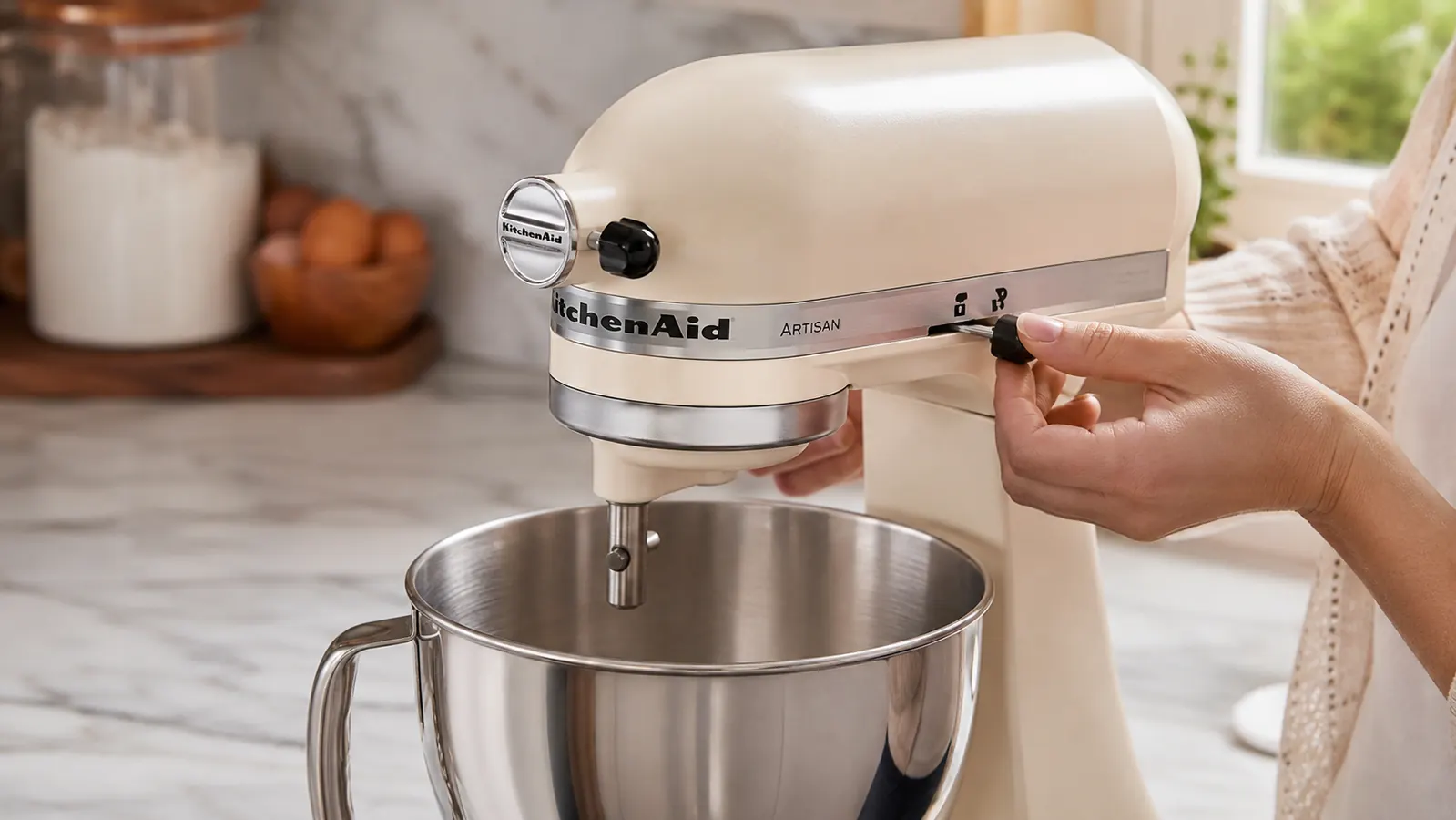 Close-up of the KitchenAid Artisan tilt-head mechanism unlocking, showing the locking lever